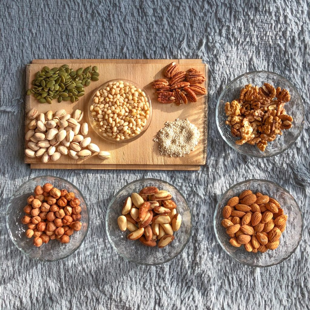 brown and white nuts on white ceramic bowls